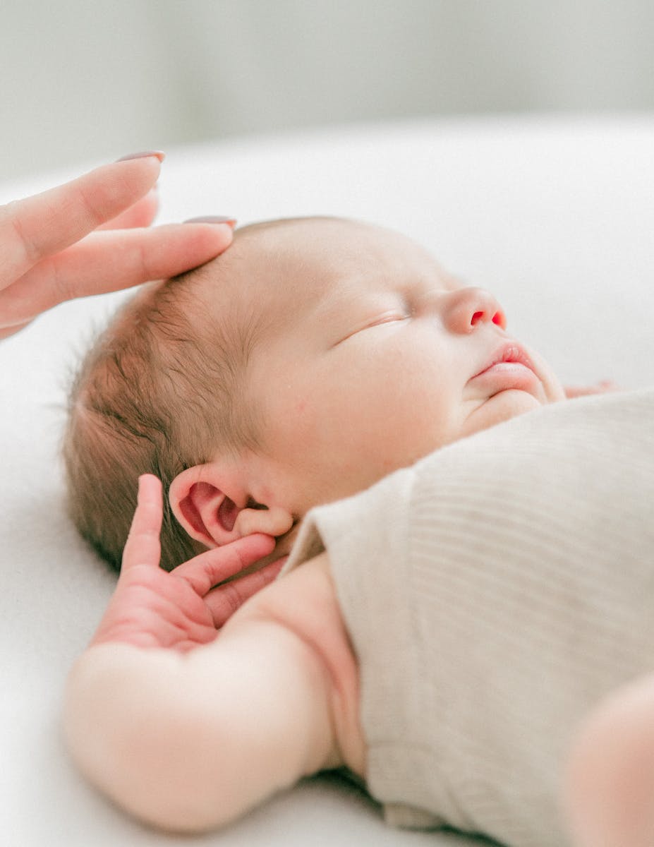 Mother Fingers over Sleeping Baby